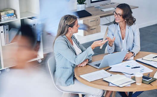 Business women in meeting, collaboration or digital marketing conversation, planning strategy for company website or seo analytics. Corporate people in work discussion, communication with laptop tech