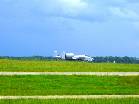 Valdosta, Georgia, USA - July 22, 2014: An A-10C Thunderbolt II at Moody Air Force Base prepares to take off on a hot, summer day as maintenance personnel make final checks on the jet.