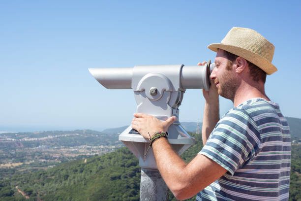 istock Male tourtist using a telescope. 1434753259