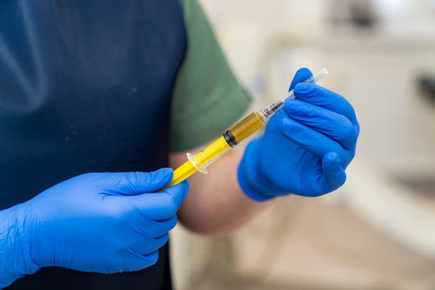 istock Hospital syringe laboratory researching. Injection prepairing in gloved hands. 1434753444