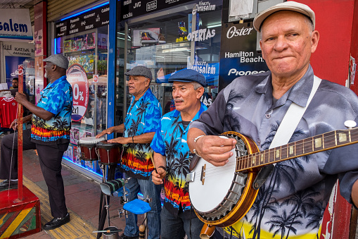 Jose, Costa Rica - September 17, 2022: Musical group performing on a pedestrian street in the urban center of the city