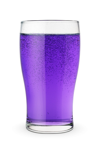 Glass of purple soda isolated on white background.