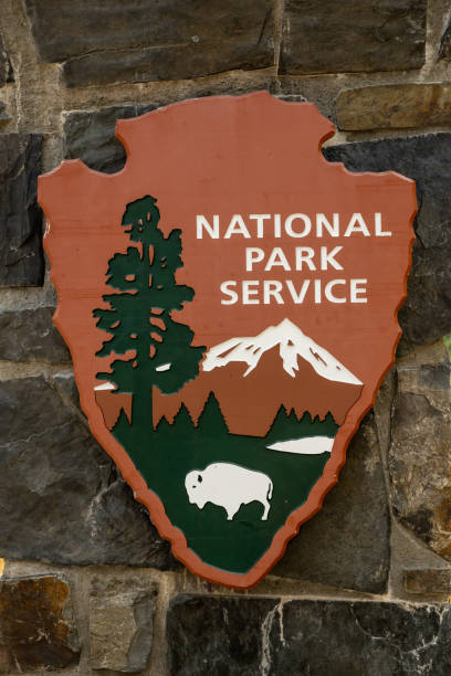 Glacier National Park, United States: July 20, 2021: National Parks Service Sign On Stone Wall