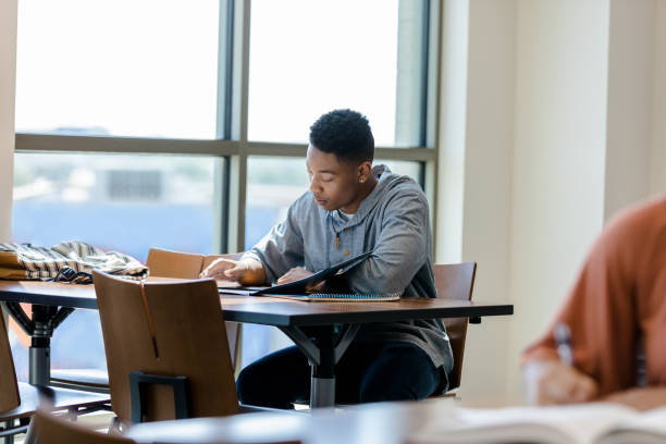 istock Young adult male reading 1434757036