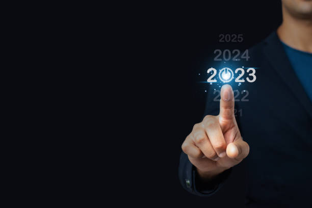 In 2023, pointing at a computerized user interface, Up until 2023, there are plans to speed up corporate growth and expansion; beginning in 2023, business planning stock photo