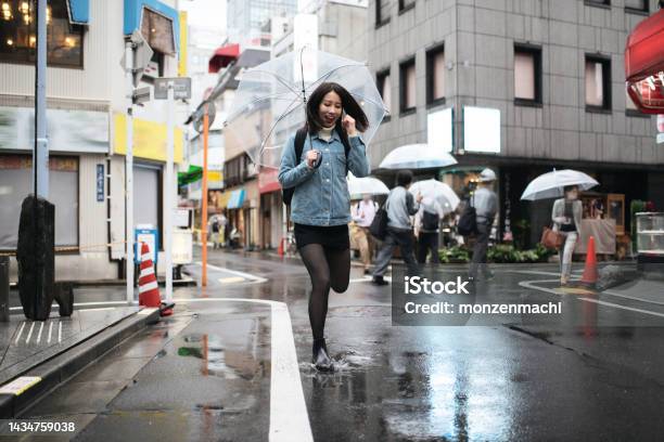 Young Woman Walking In Ueno Tokyo Japan Stock Photo - Download Image Now - Jumping, Puddle, Women