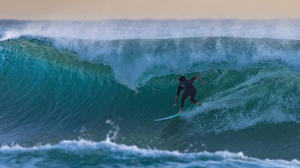 istock Scenic shot of a surfer catching a big wave 1434759350