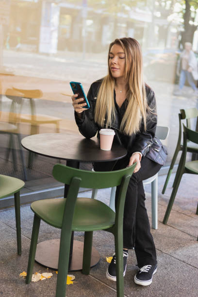 istock Beautiful young woman using smartphone 1434761053