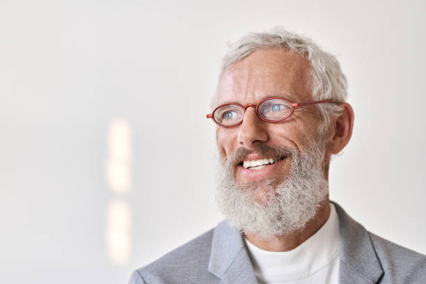 istock Smiling senior old business man looking away isolated on white wall. 1434763159