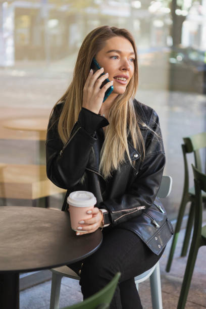 istock Beautiful young woman using smartphone 1434763502