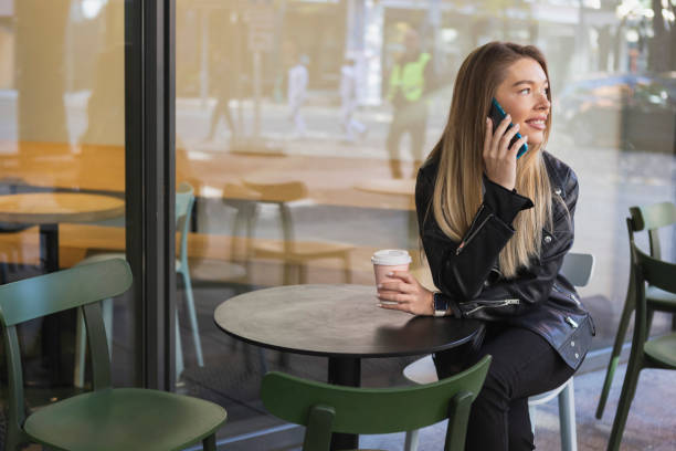 istock Beautiful young woman using smartphone 1434763526