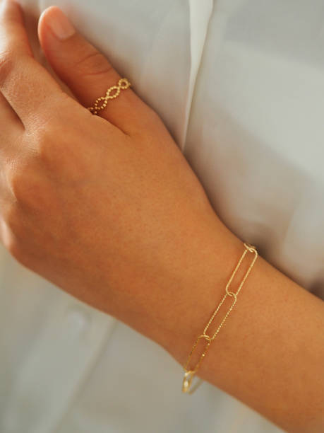 istock Gold ring and bracelet on a woman hand 1434763556
