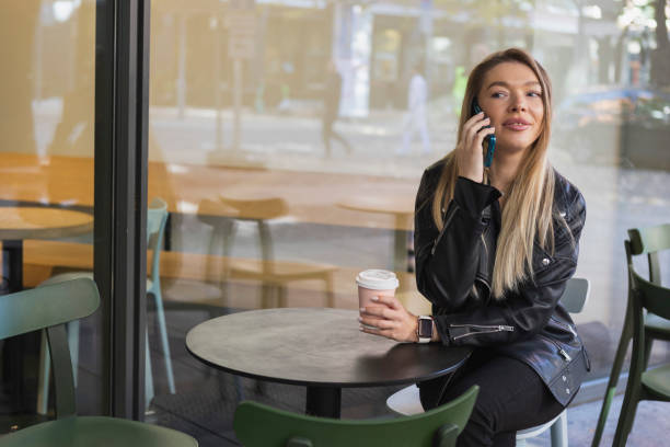 istock Beautiful young woman using smartphone 1434763576