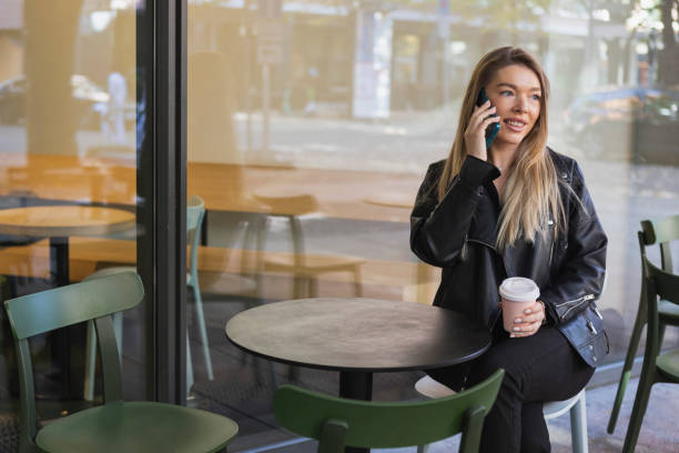 istock Beautiful young woman using smartphone 1434763758