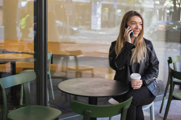 istock Beautiful young woman using smartphone 1434763903