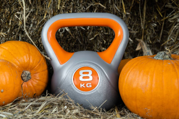 istock Gym kettlebell and pumpkins on a farm, autumn or fall composition. 1434764203