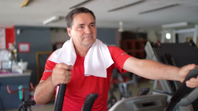 Mature man exercising on a treadmill at the gym