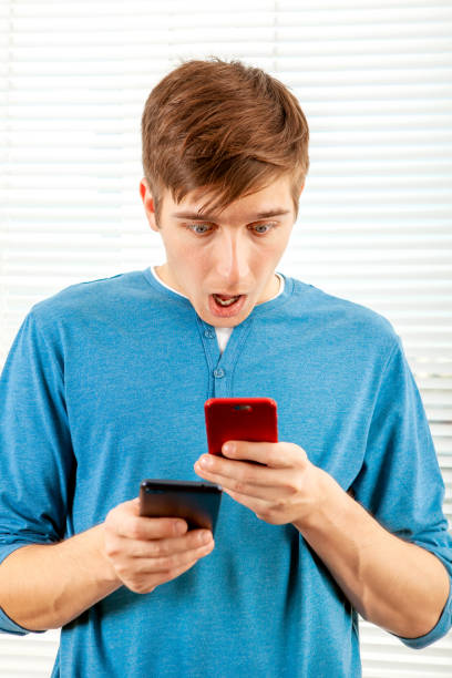 istock Shocked Young Man with a Phones 1434770463