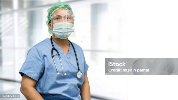 Asian Doctor Wearing Face Shield And Ppe Suit New Normal To Check Patient Protect Safety Infection Covid19 Coronavirus Outbreak At Quarantine Nursing Hospital Ward Stock Photo - Download Image Now