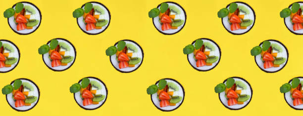 istock Fruit salad in the half coconut on the yellow background. Flat lay. Pattern. 1434772003