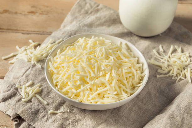 Organic Shredded Mozzarella Cheese Organic Shredded Mozzarella Cheese in a Bowl shredded mozzarella stock pictures, royalty-free photos & images