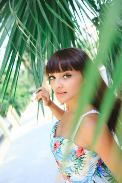 istock A girl under a palm tree on a sunny day. 1434777352