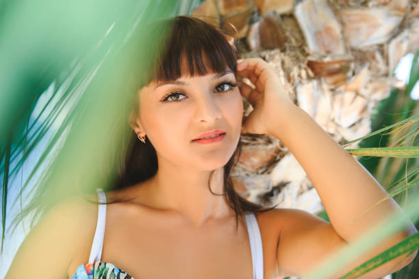 istock A girl under a palm tree on a sunny day. 1434777358