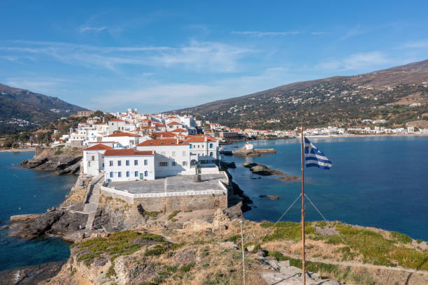 Greece. Andros Island, Traditional buildings on cape. Chora town aerial view. Andros Island, Greece. Traditional tiled roof buildings on cape and the old castle. Chora town aerial drone view. Blue sea and sky, Cyclades andros island stock pictures, royalty-free photos & images