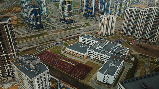 Modern urban architecture. Multi-storey buildings with infrastructure. Densely populated urban area. Overcast weather. Aerial photography.