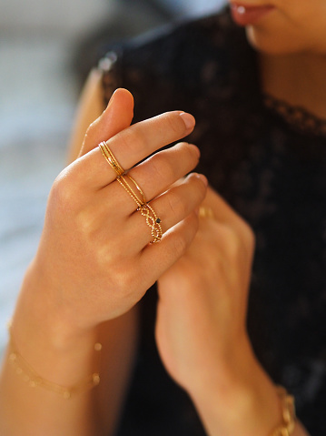 Gold rings accumulation on a woman hand
