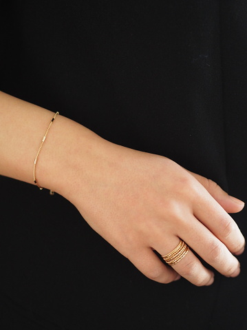 Gold bracelet and ring on a woman wrist