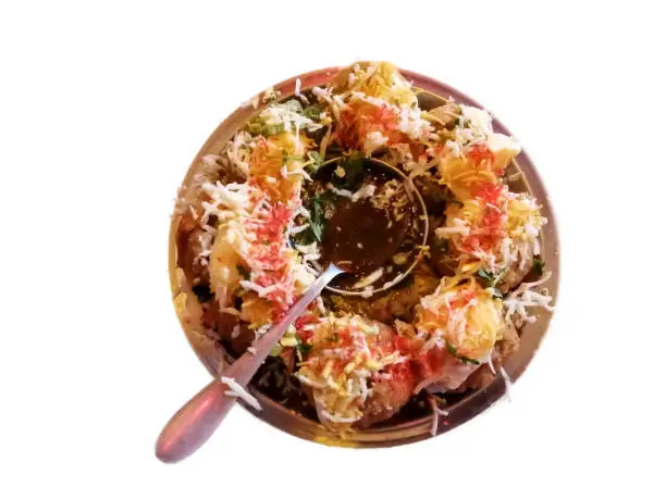 Top close view of a plate of dahi phuchka with white background, also known as Panipuri, gupchup, golgappa or pani ke patashe is a type of snack, most popular indian or bangladeshi street food.