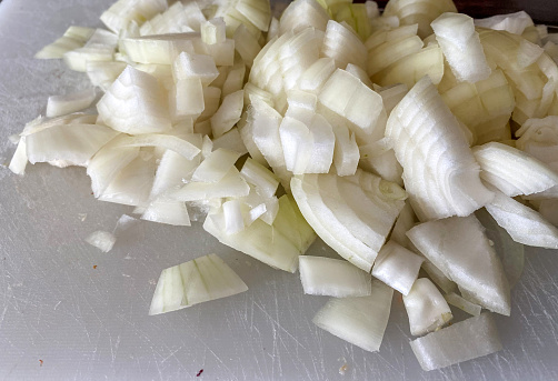 Chopped onions close up on chopping board