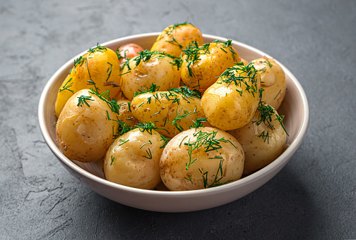 fresh potatoes on a black stone background