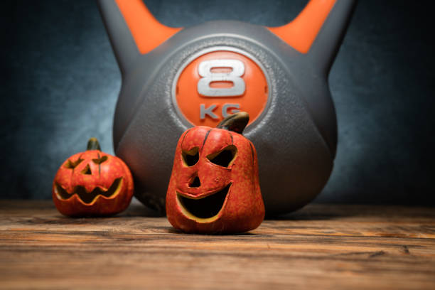 istock Halloween composition with ceramic Jack Lantern pumpkins and gym kettlebell. 1434790384