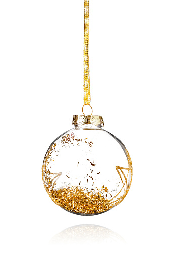 Christmas ornament with golden glitters hanging on white background. High quality photo