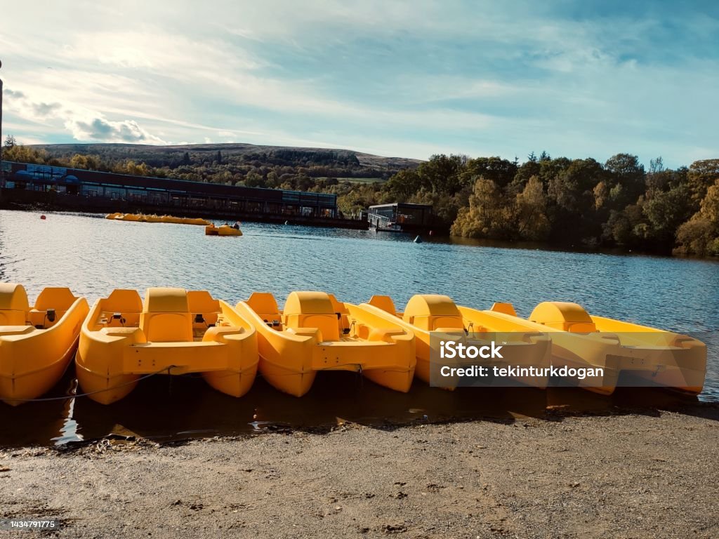 Leisure boats and canoes at coast of loch Lomond natural park at balloch glasgow scotland england uk Pedal Boat Stock Photo