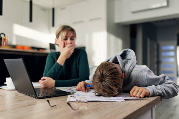 istock Frustrated mother helping frustrated son with some very difficult homework 1434791856