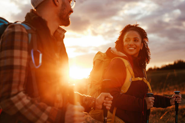 istock Multiethnic couple hiking in sunset. 1434794274