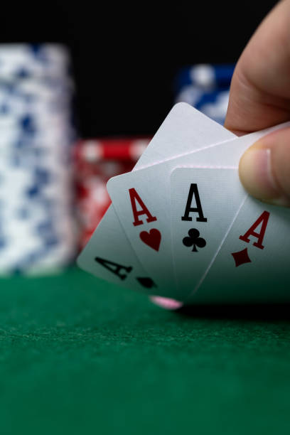 Human hand picking up four aces Human hand picking up four aces. hand of cards stock pictures, royalty-free photos & images