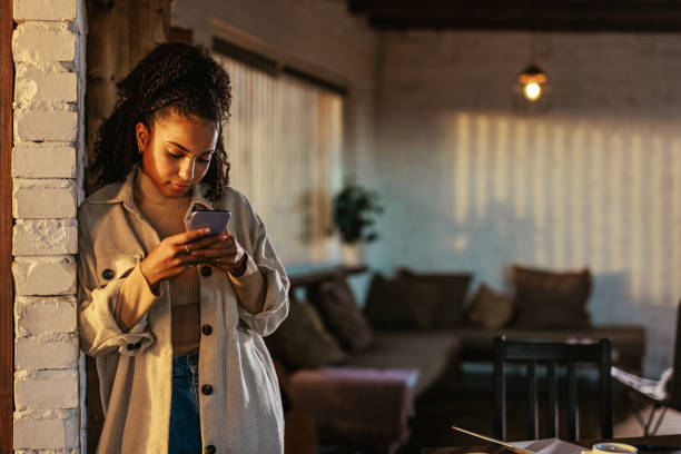 istock Woman using smartphone at home. 1434801524