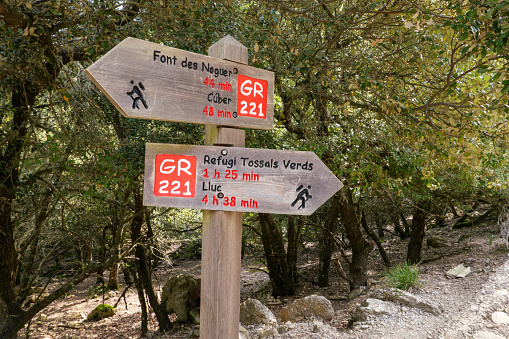 Signs and signposts during the hike in Mallorca through the Tramuntana Mountains on the long-distance hiking trail GR 221 Ruta de Pedra en Sec. towards Lluc and Cuber reservoir.