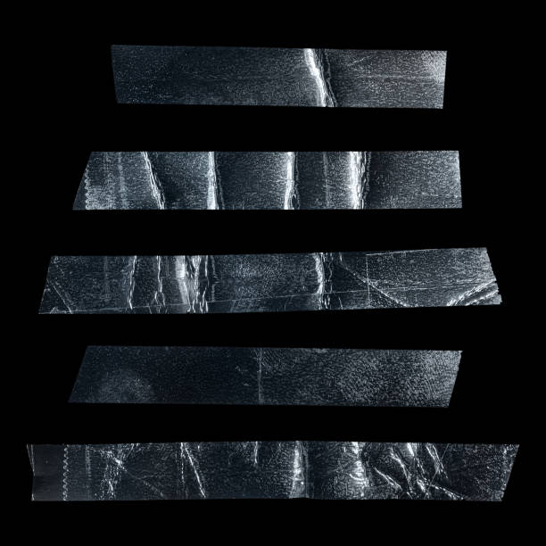 istock Metallic sticky teared tape shapes cuts isolated on black background. 1434805986