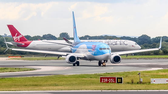 Manchester Airport, United Kingdom - 9 September 2022: TUI Boeing 737 (G-TAWA) taxiing on taxiway B1 after landing.