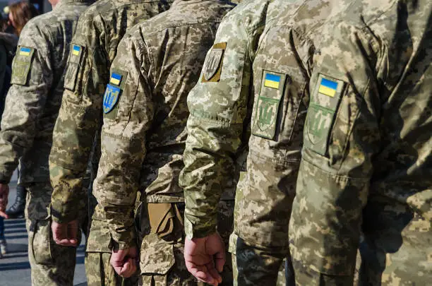 Photo of Ukrainian soldiers on military parade. Ukrainian flag on military uniform. Ukraine troops.