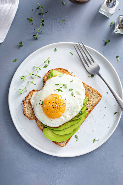 istock Avocado toast on a toasted multigrain bread with a fried egg 1434816210
