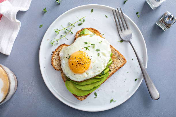 istock Avocado toast on a toasted multigrain bread with a fried egg 1434816217