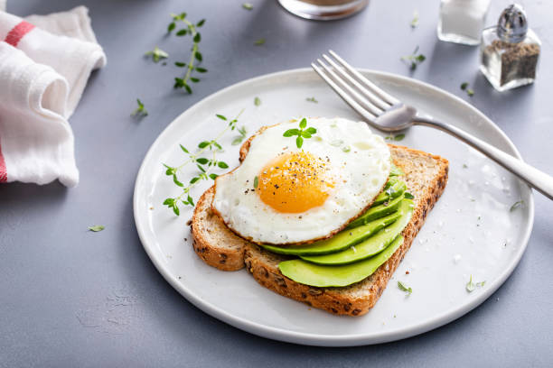 istock Avocado toast on a toasted multigrain bread with a fried egg 1434816224