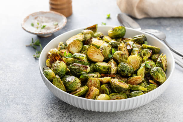 Crispy roasted or air fried brussel sprouts Crispy roasted or air fried brussel sprouts with honey dressing brussels sprout stock pictures, royalty-free photos & images