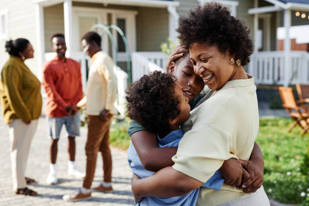 istock Black Woman Embracing Two Boys in Sunlight 1434816440